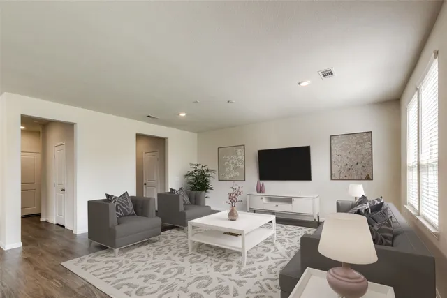 a living room with furniture couches and a flat screen tv