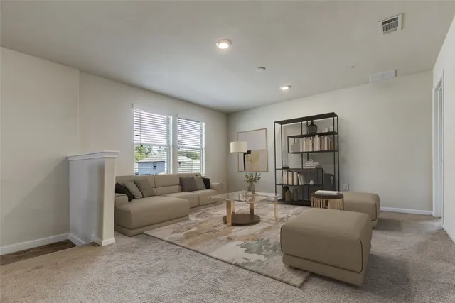 a living room with furniture and a large window