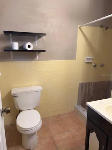 a bathroom with a small shower