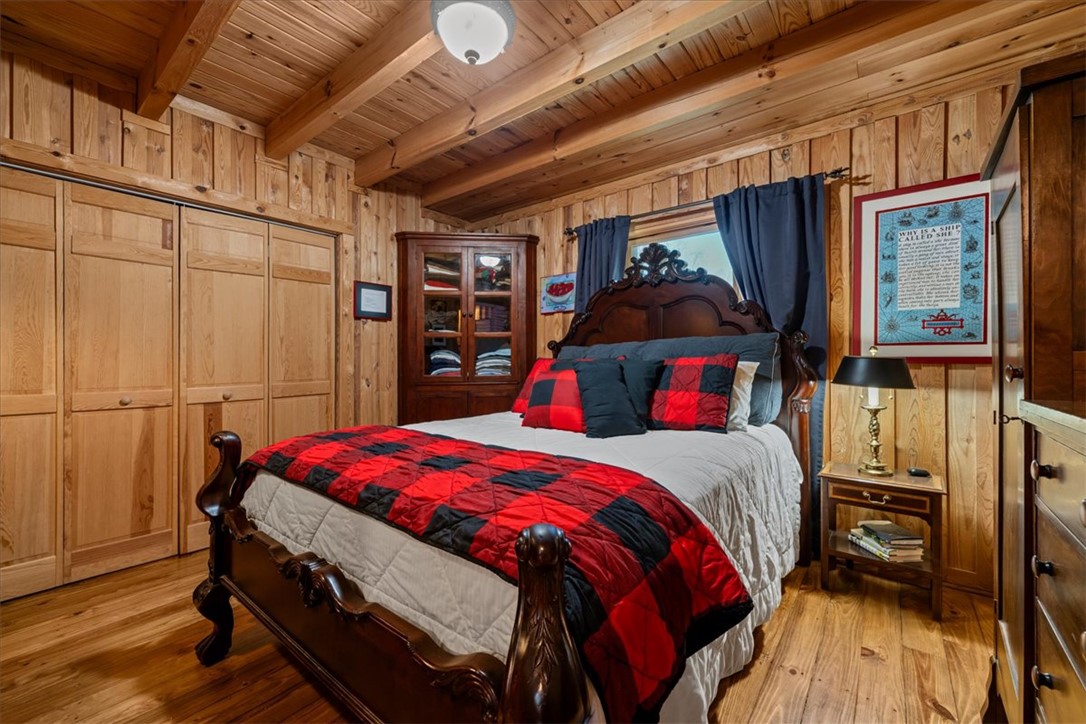 109 Carolina Cove Road Seneca, SC 29672 - Photo 18 of 45 This cozy bedroom features warm wood finishes, creating an inviting and rustic ambiance perfect for unwinding.