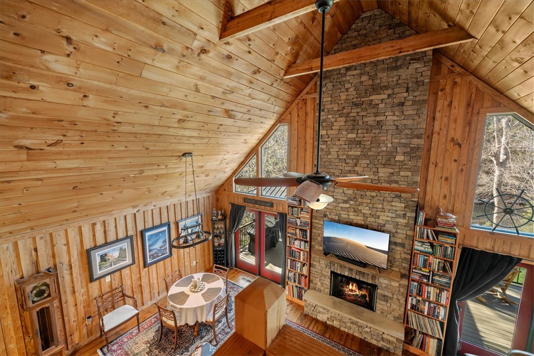 109 Carolina Cove Road Seneca, SC 29672 - Photo 20 of 45 This living space features high wood ceilings & beams & a prominent stacked stone fireplace.
