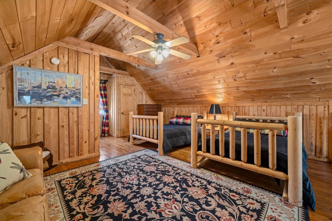 109 Carolina Cove Road Seneca, SC 29672 - Photo 21 of 45 The loft bedroom offers rustic charm with a dormer window and exposed beams. Twin beds convey with the sale. Also a great place to have the pool table that also conveys with the home.
