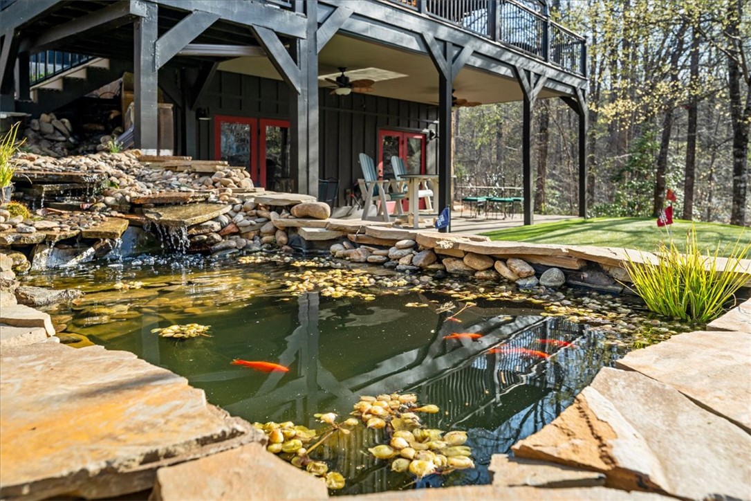 109 Carolina Cove Road Seneca, SC 29672 - Photo 34 of 45 This serene outdoor oasis features a tranquil pond with a waterfall, perfect for relaxation between the fire pit and putting green.