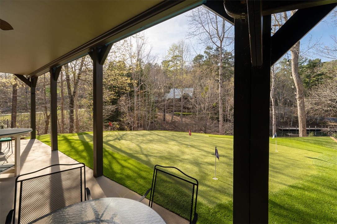 109 Carolina Cove Road Seneca, SC 29672 - Photo 36 of 45 This covered patio offers serene views of a private putting green, perfect for leisurely afternoons.