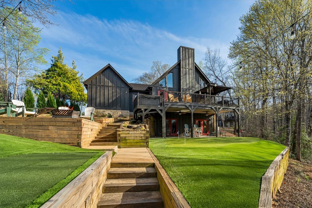109 Carolina Cove Road Seneca, SC 29672 - Photo 4 of 45 This home features expansive outdoor entertaining spaces. The putting green was recently installed by Southwest Greens of Asheville and features 4 holes & chipping area.
