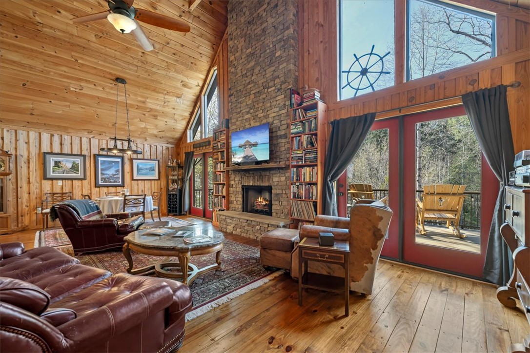 109 Carolina Cove Road Seneca, SC 29672 - Photo 7 of 45 This inviting living room features a fireplace and offers direct access to an outdoor deck.