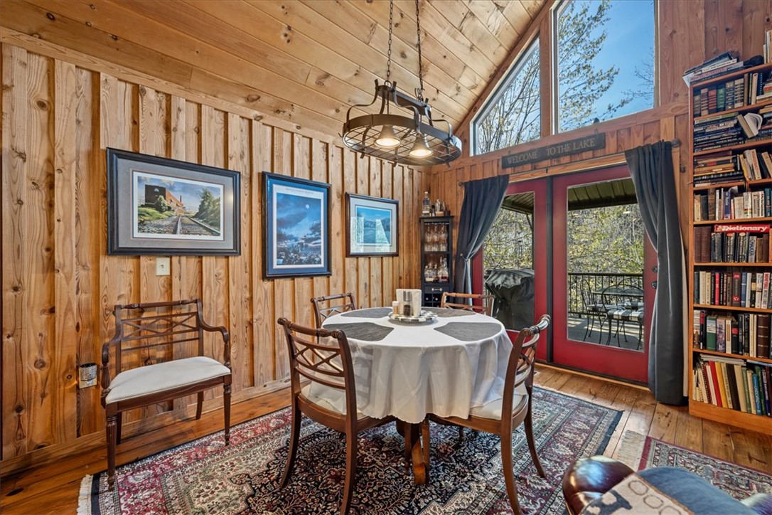 109 Carolina Cove Road Seneca, SC 29672 - Photo 10 of 45 This dining area features rich wood paneling, an inviting chandelier, and access to the large back deck.