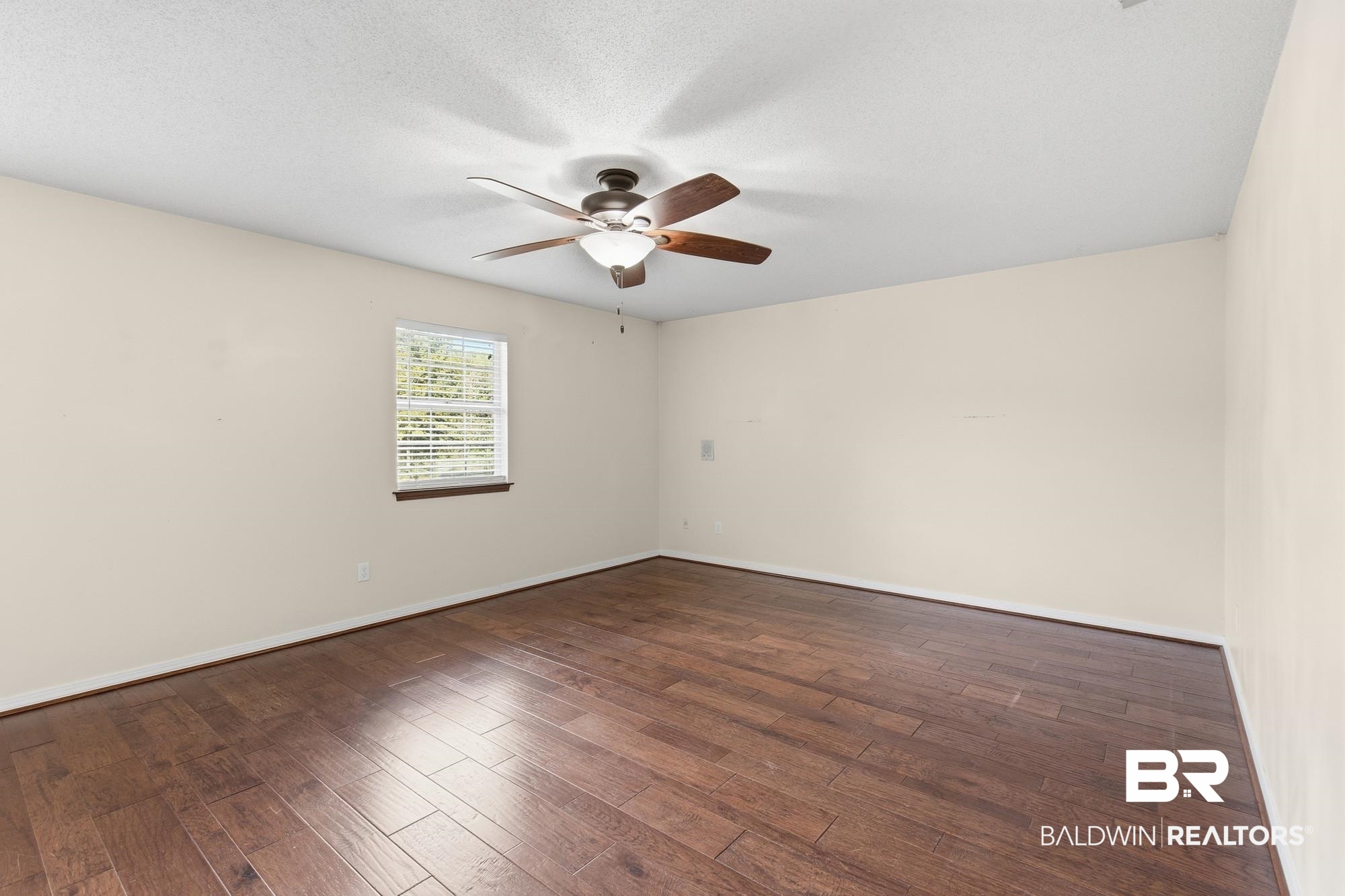 9215 Shiloh Drive Mobile, AL 36695 - Photo 17 of 32 Empty room with dark wood-style flooring, a textured ceiling, and a ceiling fan