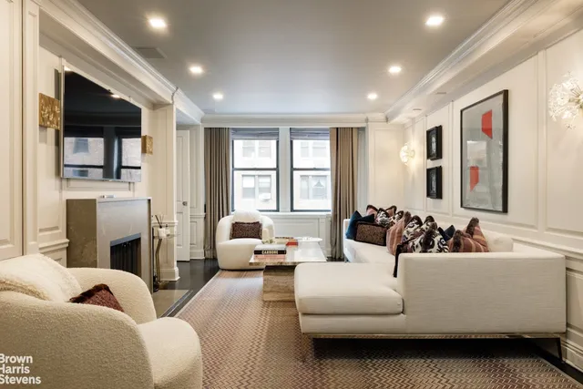 a living room with furniture fireplace and window