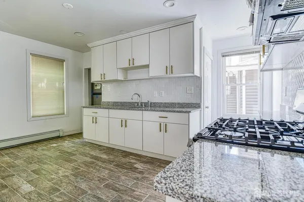a stove top oven sitting inside of a kitchen