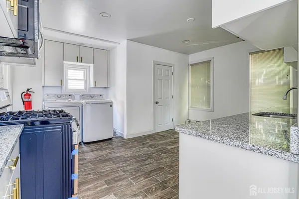 a utility room with sink dryer and washer