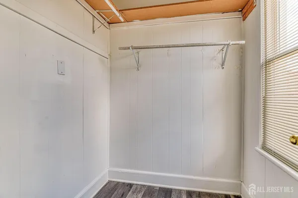 a view of a hallway with wooden floor and entryway