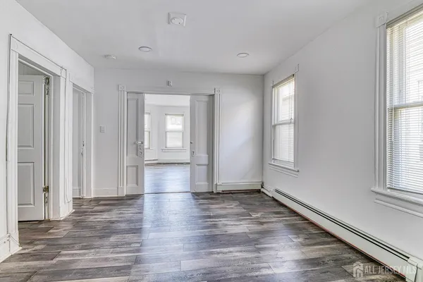 a kitchen with a stove window and cabinets