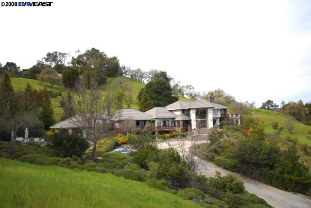 a view of a house with a yard and sitting area