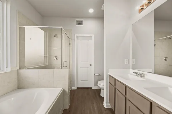 a bathroom with a tub sink and a mirror