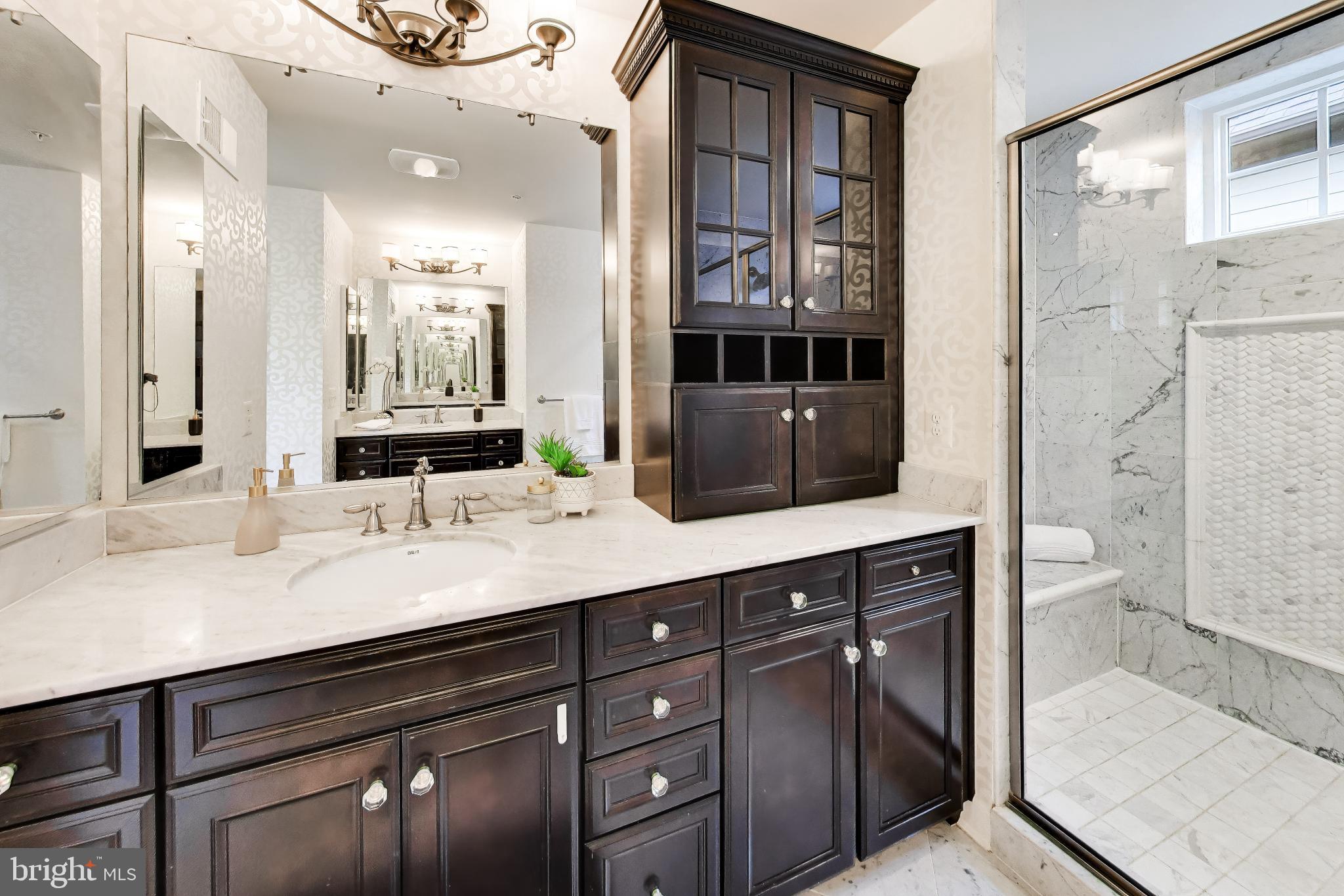 13513 Moonlight Trail Drive Silver Spring, MD 20906 - Photo 29 of 78 a bathroom with a granite countertop sink a mirror and a shower