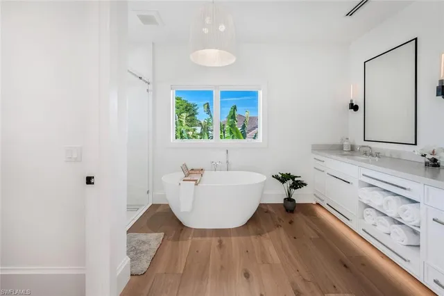 a white bath tub sitting next to a white sink