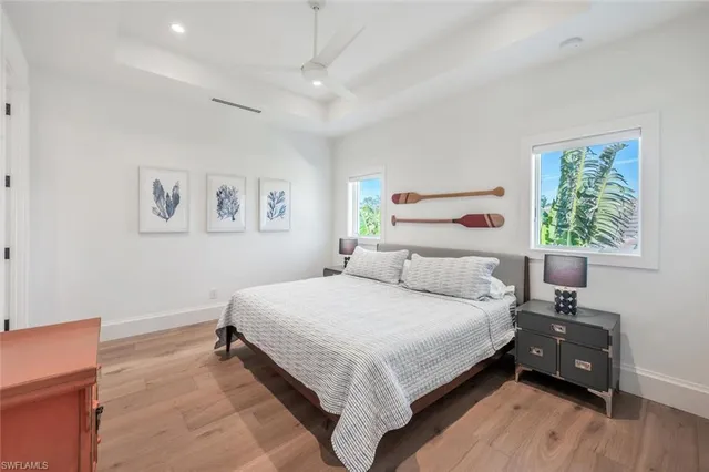 a bedroom with bed and wooden floor