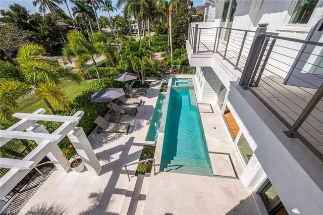 a view of a house with a yard and potted plants