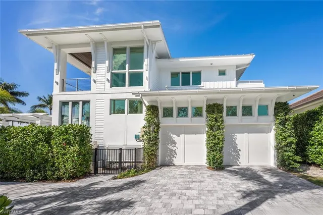 a view of a patio with chairs and table under an umbrella