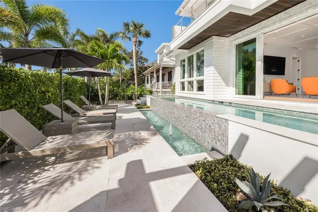 a view of a house with backyard porch and sitting area