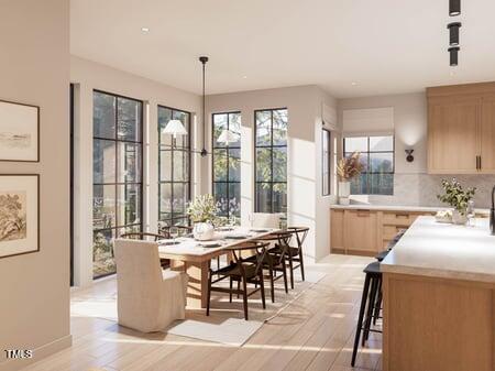 8016 Penny Road Raleigh, NC 27606 - Photo 11 of 23 a view of a dining room and livingroom with furniture wooden floor a chandelier