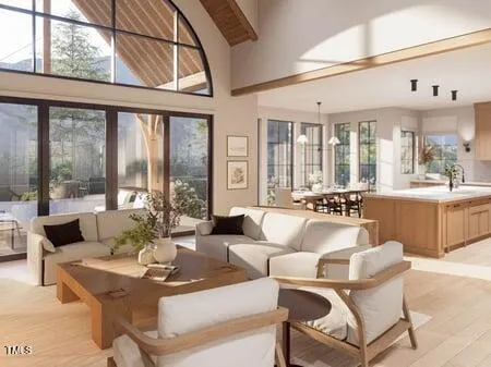 a living room with furniture large windows and wooden floor