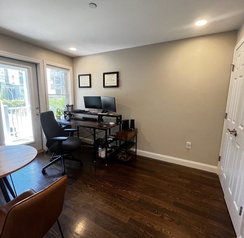 229 Maverick Street, Unit 1 Boston, MA 02128 - Photo 12 of 20 a view of a livingroom with workspace and a window