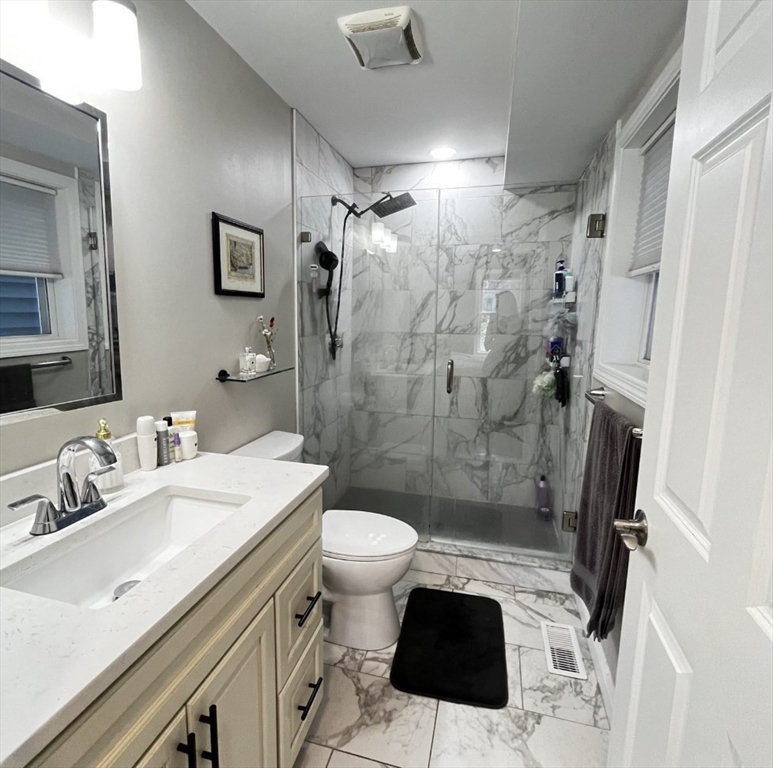 229 Maverick Street, Unit 1 Boston, MA 02128 - Photo 14 of 20 a bathroom with a sink toilet and shower