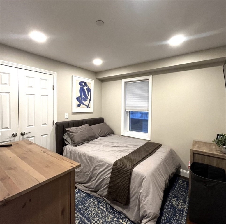 229 Maverick Street, Unit 1 Boston, MA 02128 - Photo 15 of 20 a bedroom with two beds and a dresser