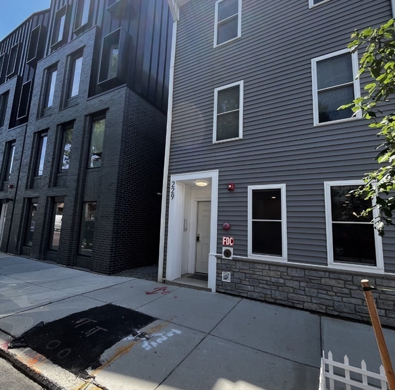 229 Maverick Street, Unit 1 Boston, MA 02128 - Photo 19 of 20 a view of a house with many windows