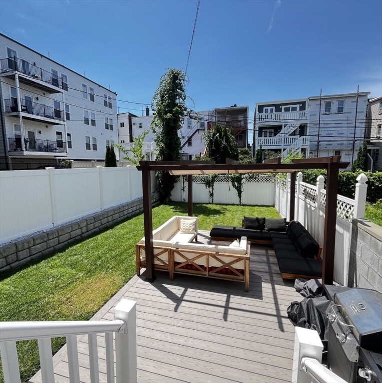 229 Maverick Street, Unit 1 Boston, MA 02128 - Photo 3 of 20 a view of a chairs and table in patio with a yard