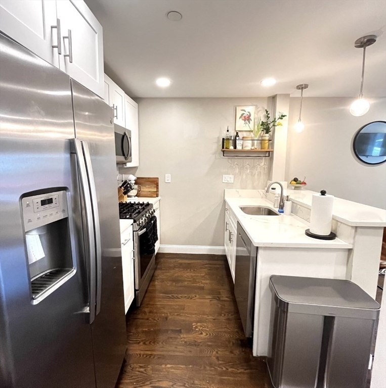 229 Maverick Street, Unit 1 Boston, MA 02128 - Photo 6 of 20 a kitchen with a sink and refrigerator