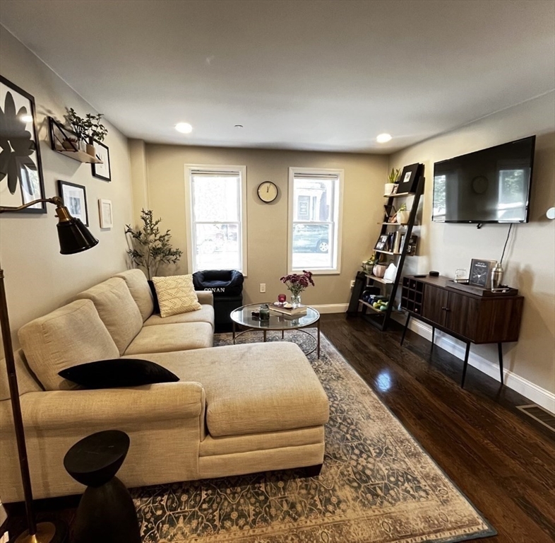 229 Maverick Street, Unit 1 Boston, MA 02128 - Photo 9 of 20 a living room with furniture and a flat screen tv