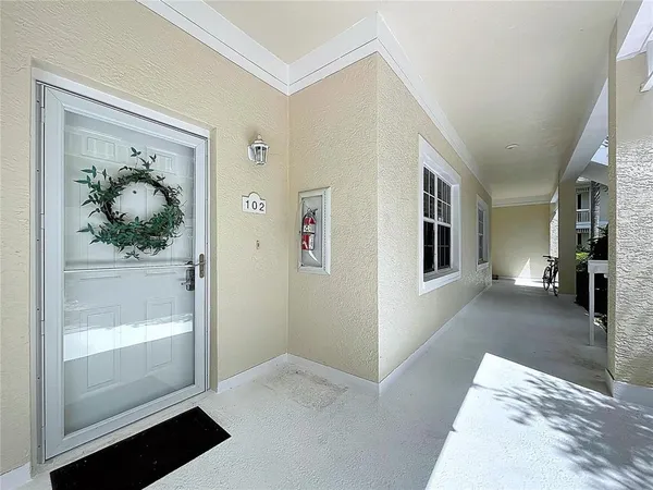 a view of a hallway view with wooden floor and front door