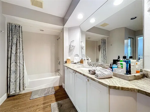 a bedroom with two beds and a chandelier