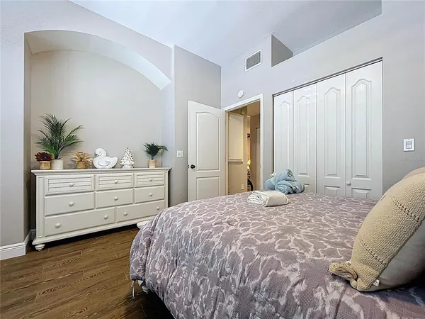 a bathroom with a granite countertop sink a toilet and a mirror