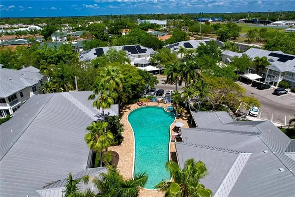 an aerial view of residential houses with outdoor space
