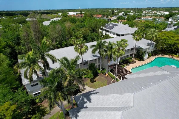 an aerial view of residential houses with outdoor space
