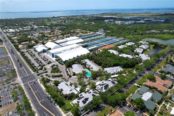 an aerial view of residential houses with outdoor space and pool