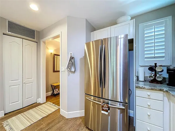 a kitchen with cabinets and chairs