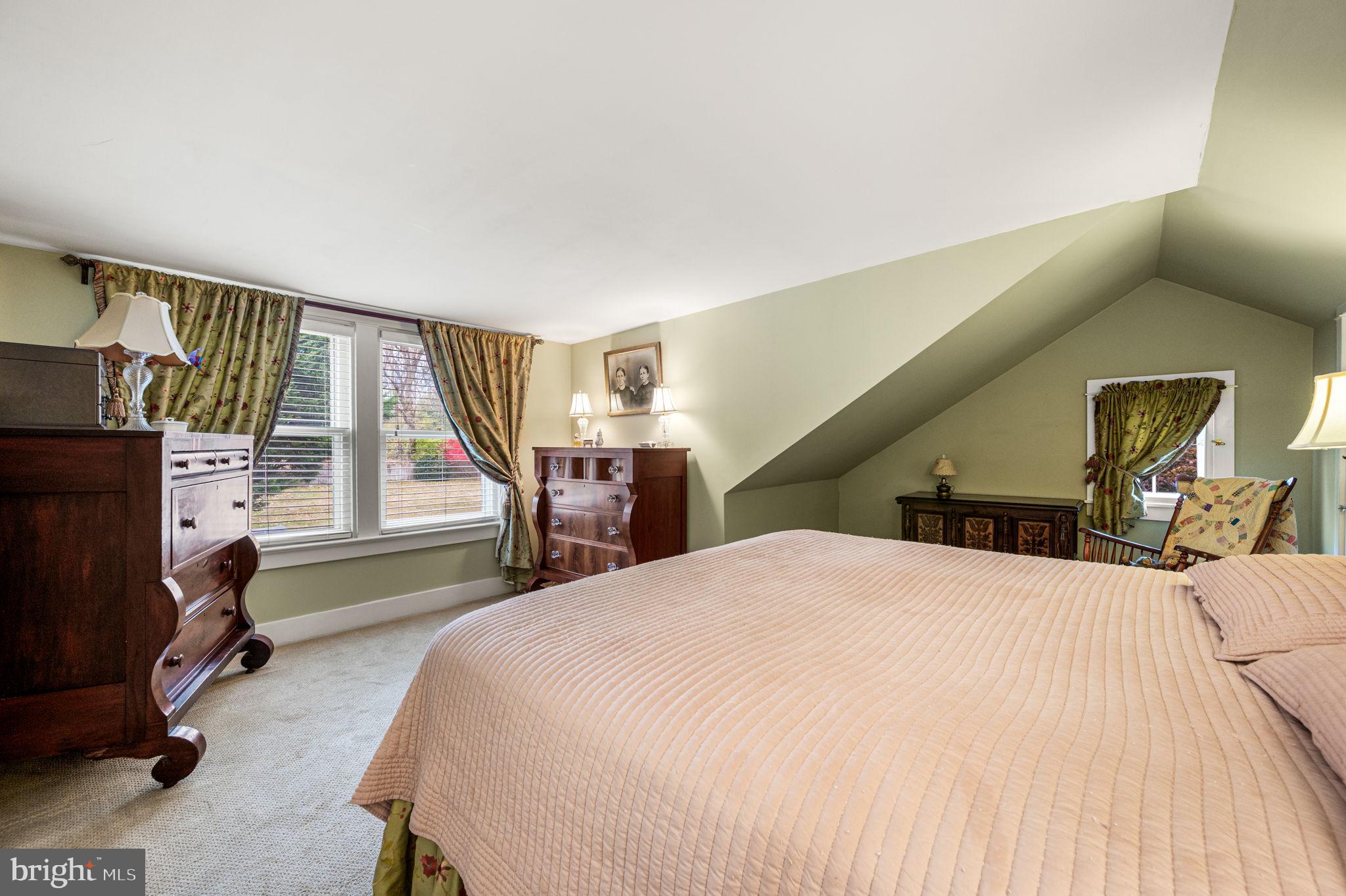 1033 Lenape Road West Chester, PA 19382 - Photo 16 of 33 a bedroom with a bed couch and a flat tv screen
