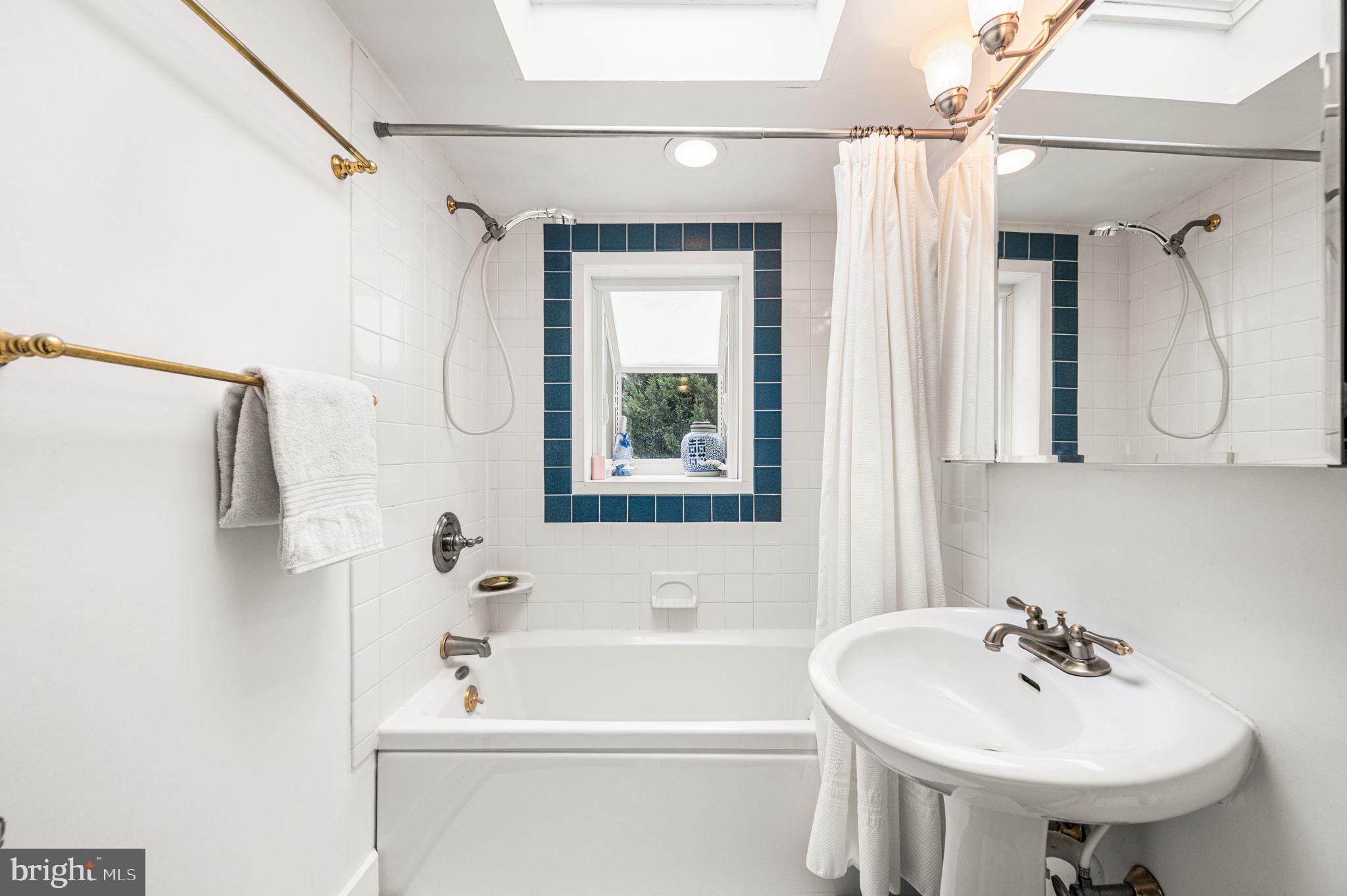 1033 Lenape Road West Chester, PA 19382 - Photo 20 of 33 a bathroom with a sink a mirror and a shower