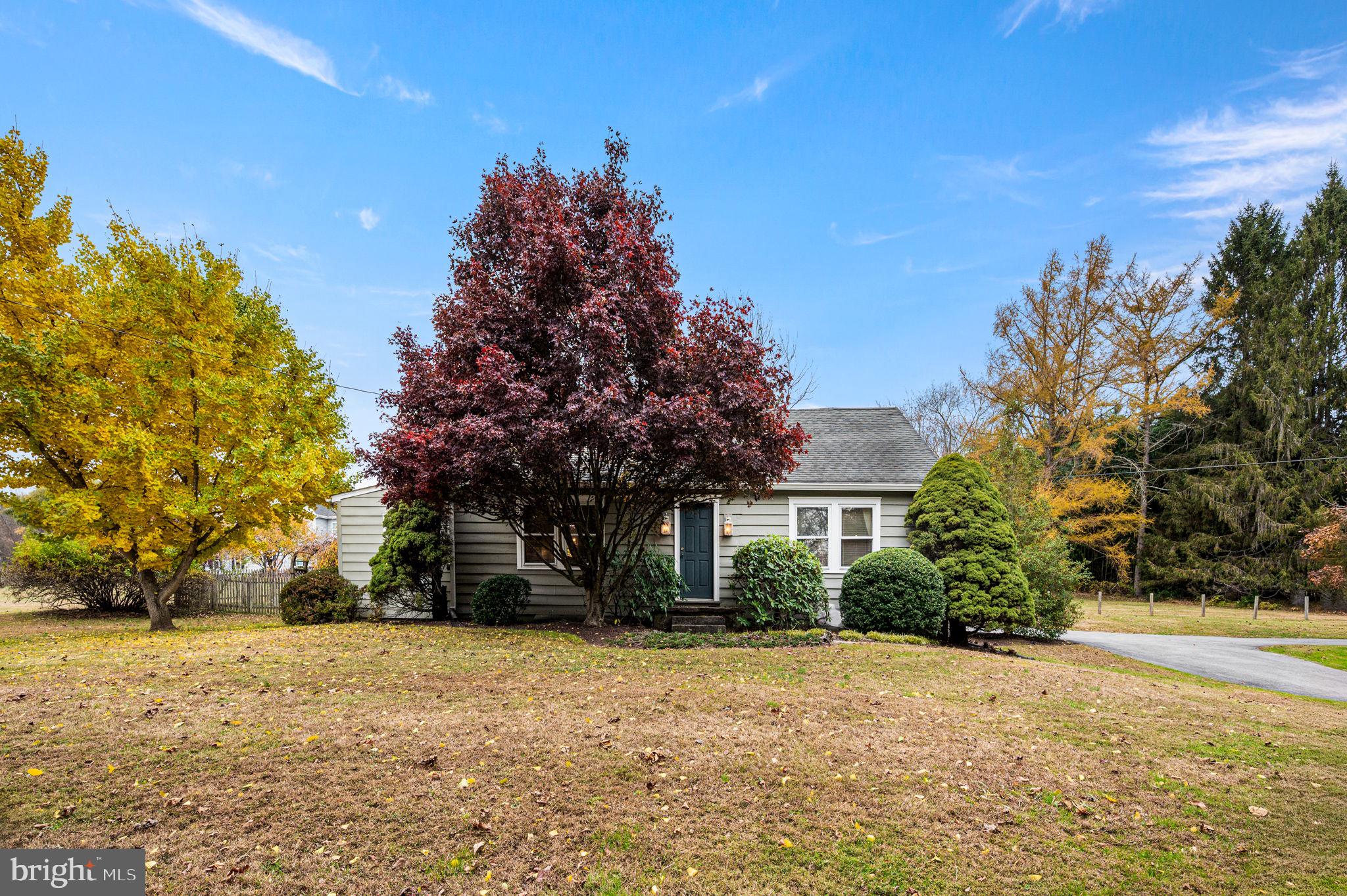 1033 Lenape Road West Chester, PA 19382 - Photo 25 of 33 a yellow house with trees in front of it