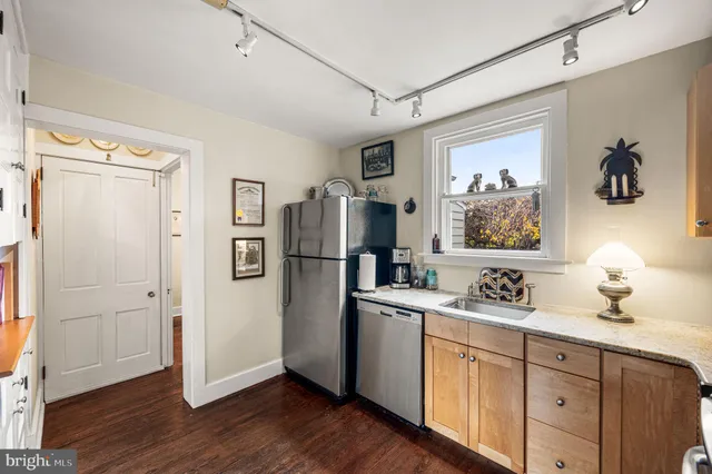 a kitchen with a refrigerator and cabinets