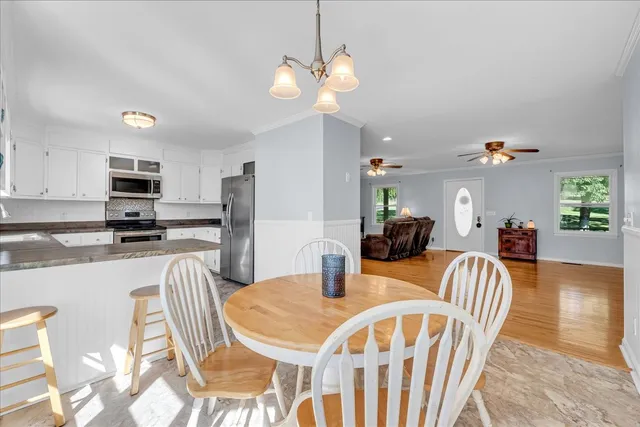 a kitchen with granite countertop a refrigerator stove top oven and sink