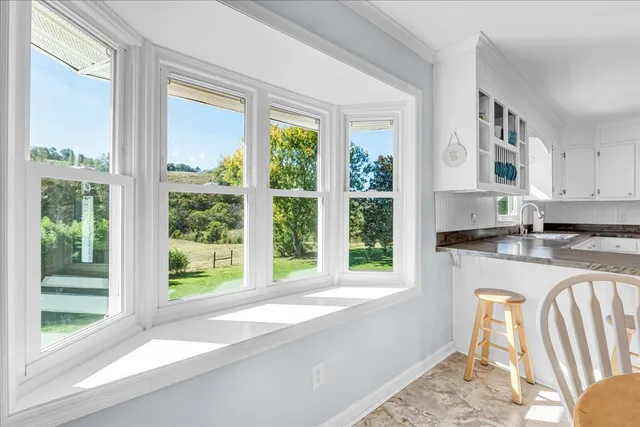 a kitchen with granite countertop stainless steel appliances a stove sink and microwave