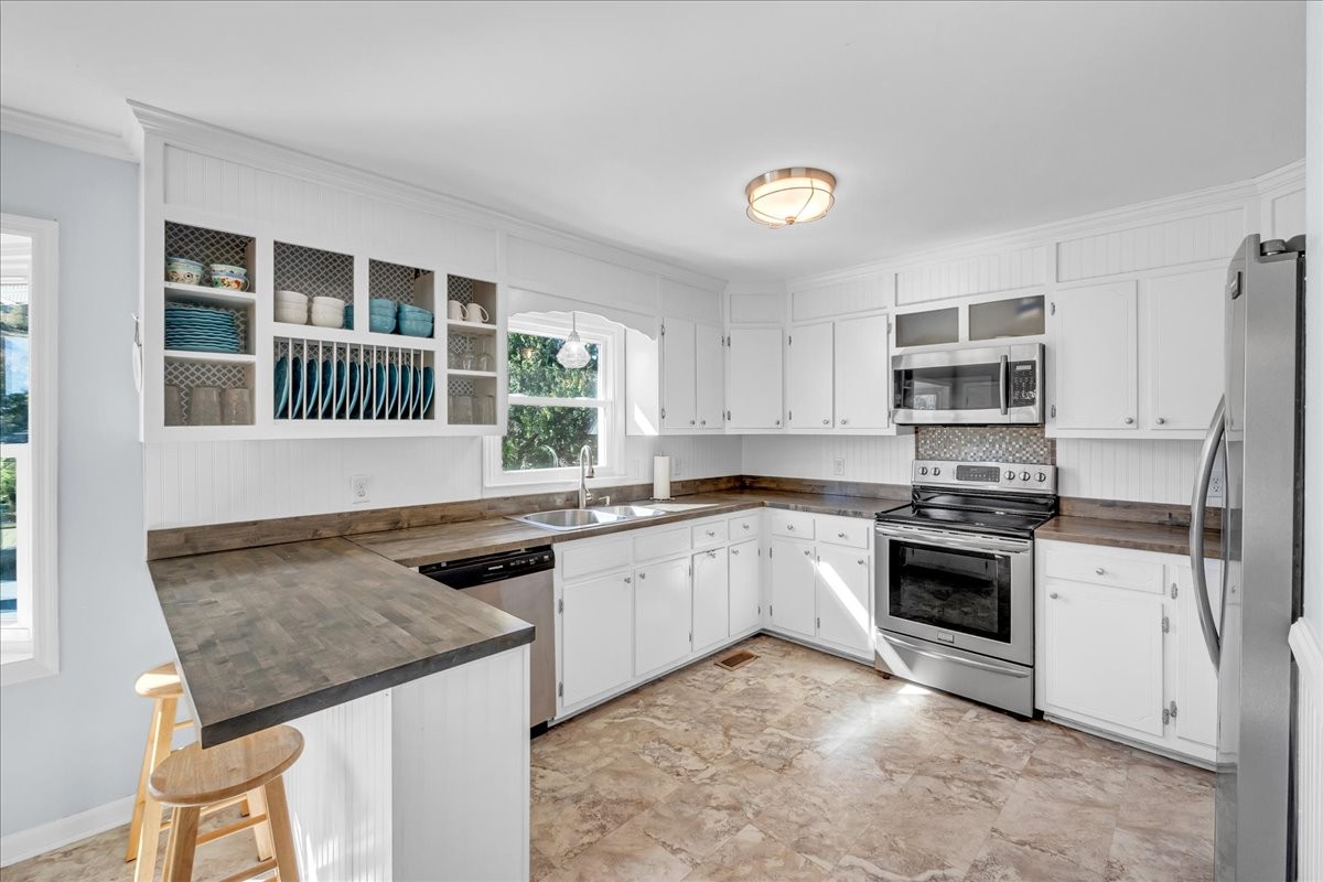 487 County Line Road Lynchburg, TN 37352 - Photo 16 of 63 a kitchen with granite countertop stainless steel appliances a stove sink and microwave