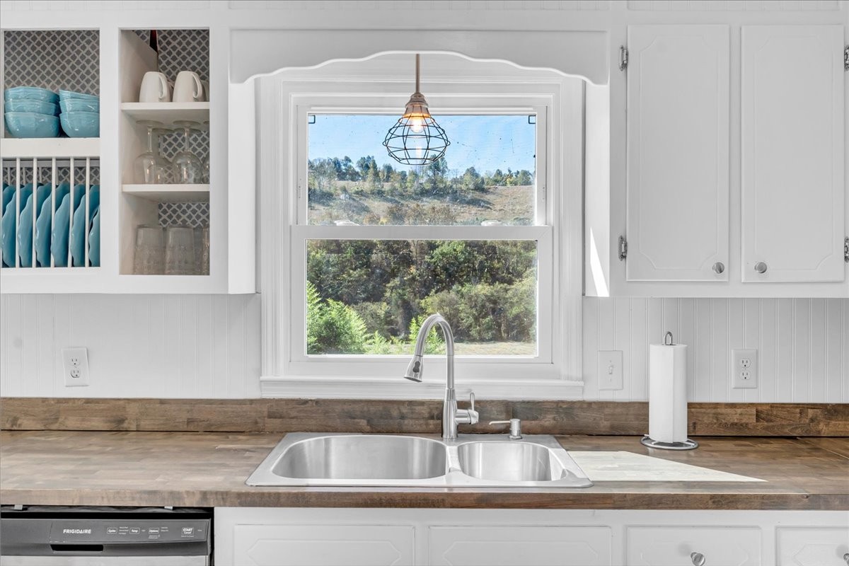 487 County Line Road Lynchburg, TN 37352 - Photo 18 of 63 a kitchen with granite countertop a sink and a counter top space