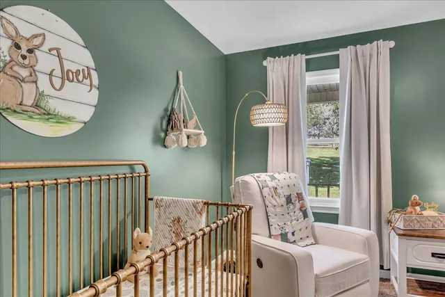 a bedroom with a large bed and a chandelier